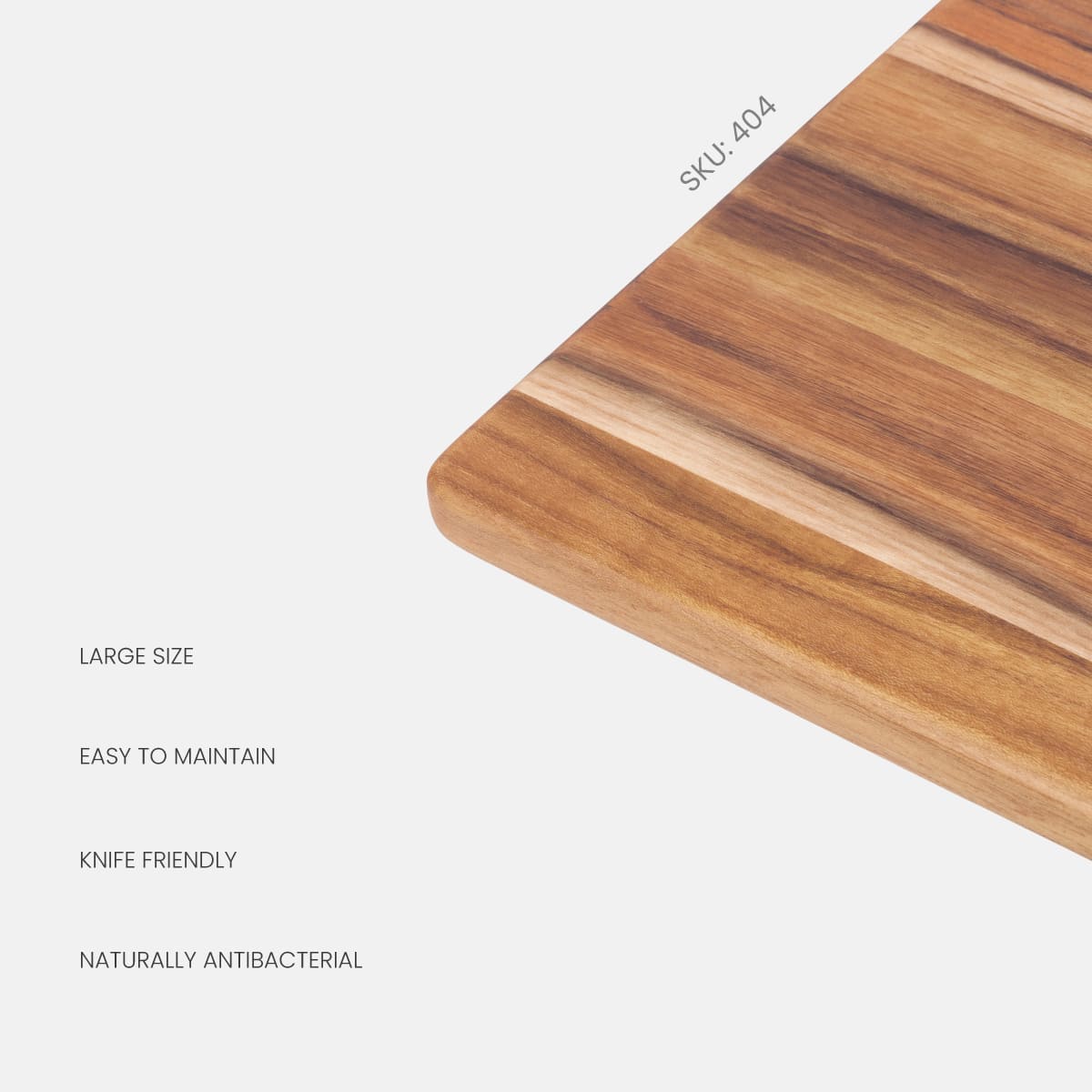 Close-up of a large teakwood edge grain cutting board corner with rich natural wood patterns and product features.