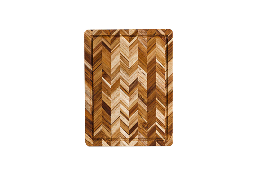Rectangular teak wood cutting board featuring a striking herringbone pattern and functional perimeter juice canal.