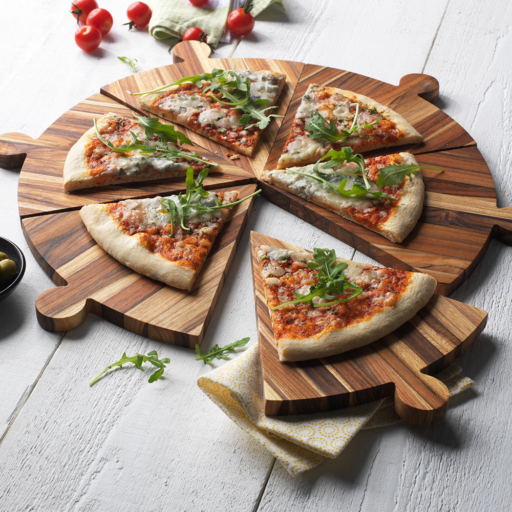 Modular teakwood pizza platter in six triangular pieces with handles, featuring pizza on a white wood table.