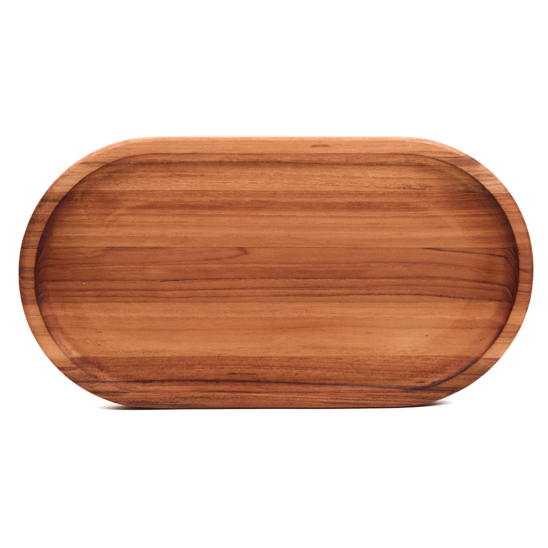 Small edge grain teakwood oval serving tray with a narrow rim on a white background.