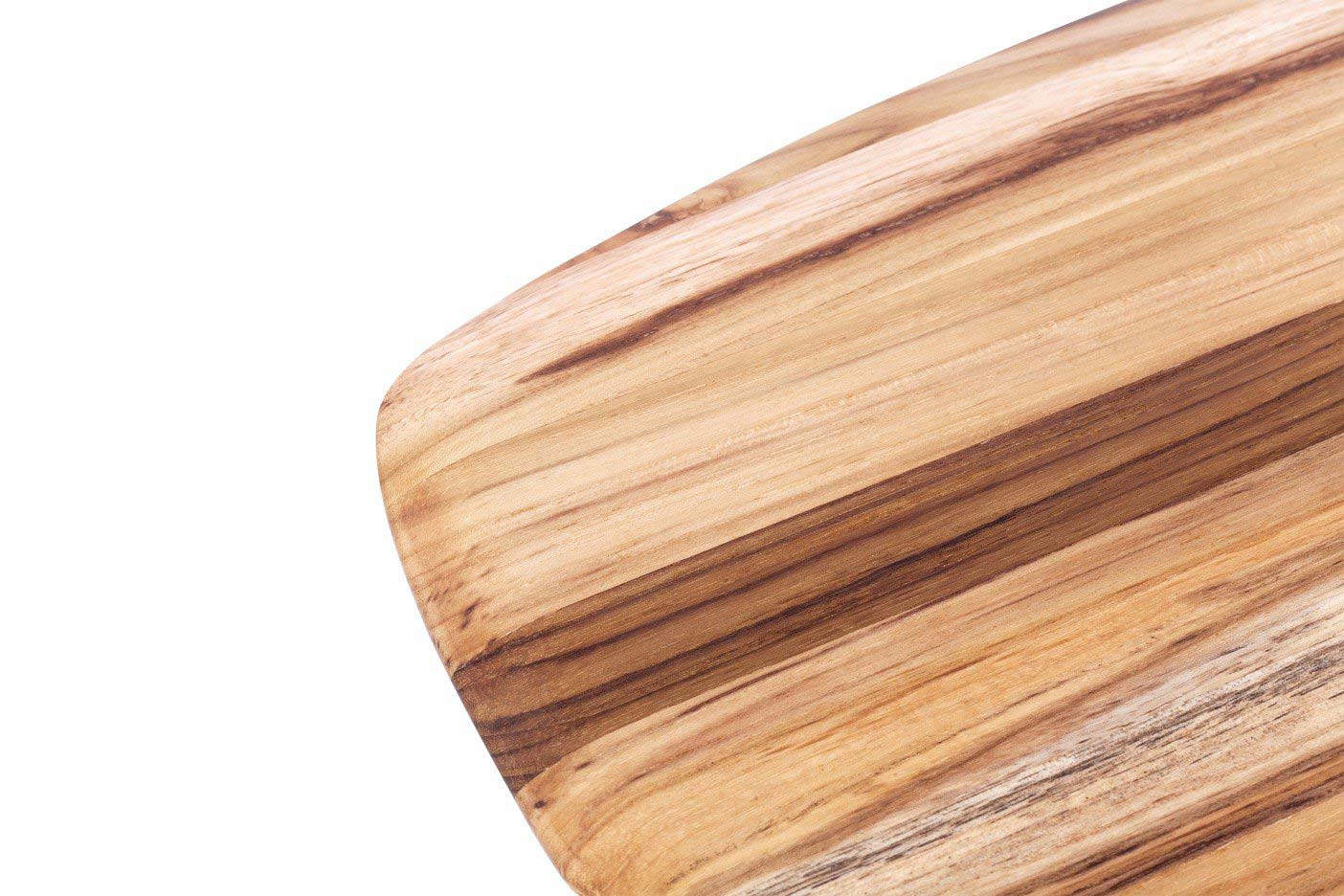Teak wood serving board corner featuring a smooth rounded edge and natural edge grain patterns.