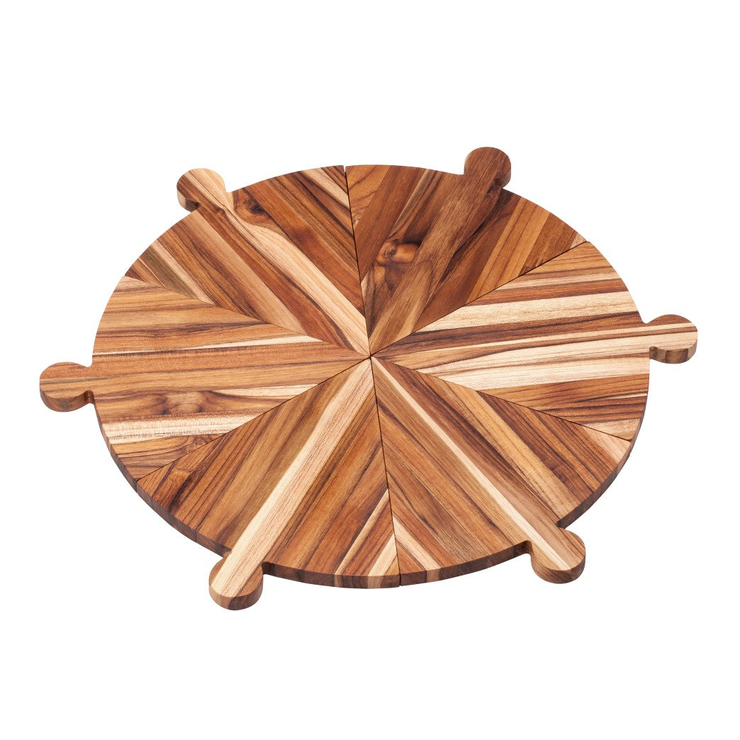 Circular teakwood pizza platter made of six triangular edge grain pieces featuring small integrated handles.